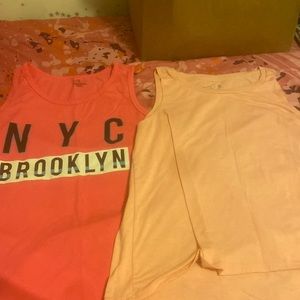 Pink tank tops. Both are large. Just don’t need the extra clothes